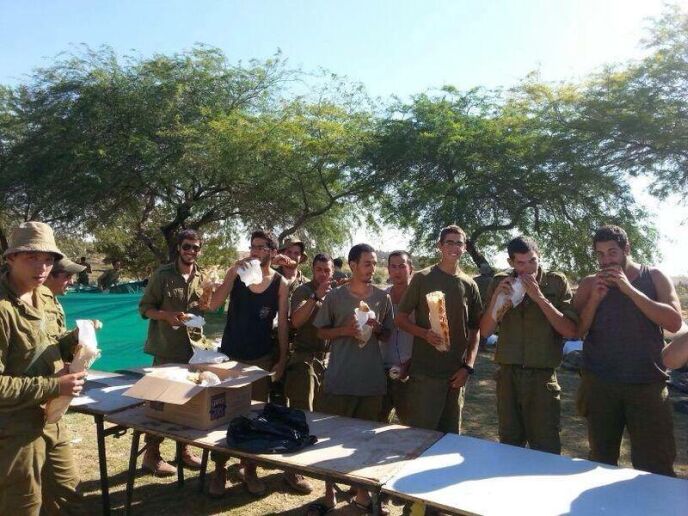 Soldiers enjoying their free sandwiches. 