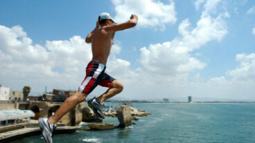 Taking the plunge in Akko. Photo by Shay Levy/FLASH90.