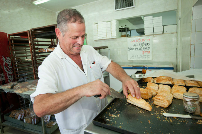 An Israeli chef prepares bourekas at a restaurant in Beersheva. (Photo by Moshe Shai/FLASH90)