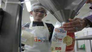 A young Pantry Packer on the job. Photo courtesy of Colel Chabad