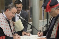 From left, Jordanian Red Crescent director Dr. Mohammed al-Hadid (with assistant Mohd Hadid), signing diplomas with BGU Rector Prof. Zvi Hacohen. Photo by Yoav Galai/BGU