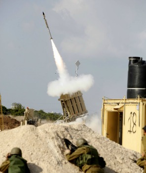 Israeli soldiers take cover as an Iron Dome battery intercepts a rocket fired from Gaza, November 19, 2012. Photo by Edi Israel/Flash90