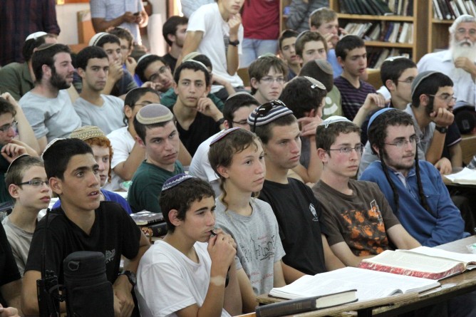 Students of the Mekor Chaim yeshiva in Kibbutz Kfar Etzion, where two of the three kidnapped boys were students, listening to Israeli Minister of Economics Naftali Bennett addressing them on June 16, 2014. (Photo by Gershon Elinson/FLASH90)