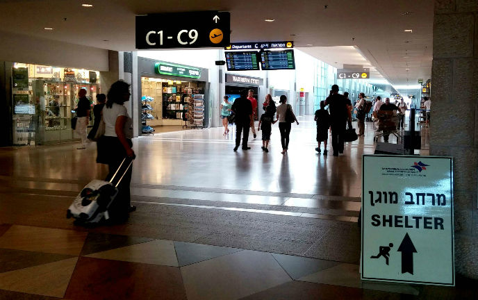 Signs at the Ben-Gurion Airport point visitors to a bomb shelter. Photo by Tzahi Ben Ami/FLASH90.