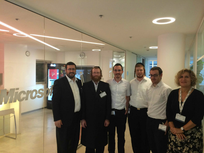 KamaTech founders Moshe Friedman and Zika Abzuk at the Microsoft R&D center, flanking four Haredi students placed by KamaTech at Microsoft, Marvel and Check Point.