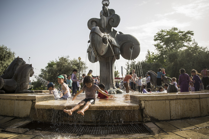 Children try to cool off in a water fountain in Jerusalem. (Photo by Hadas Parush/FLASh90)
