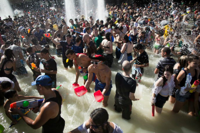 Israelis spray each other during a fun water fight at Rabin Square in Tel Aviv. Photo by Yonatan Sindel/FLASH90