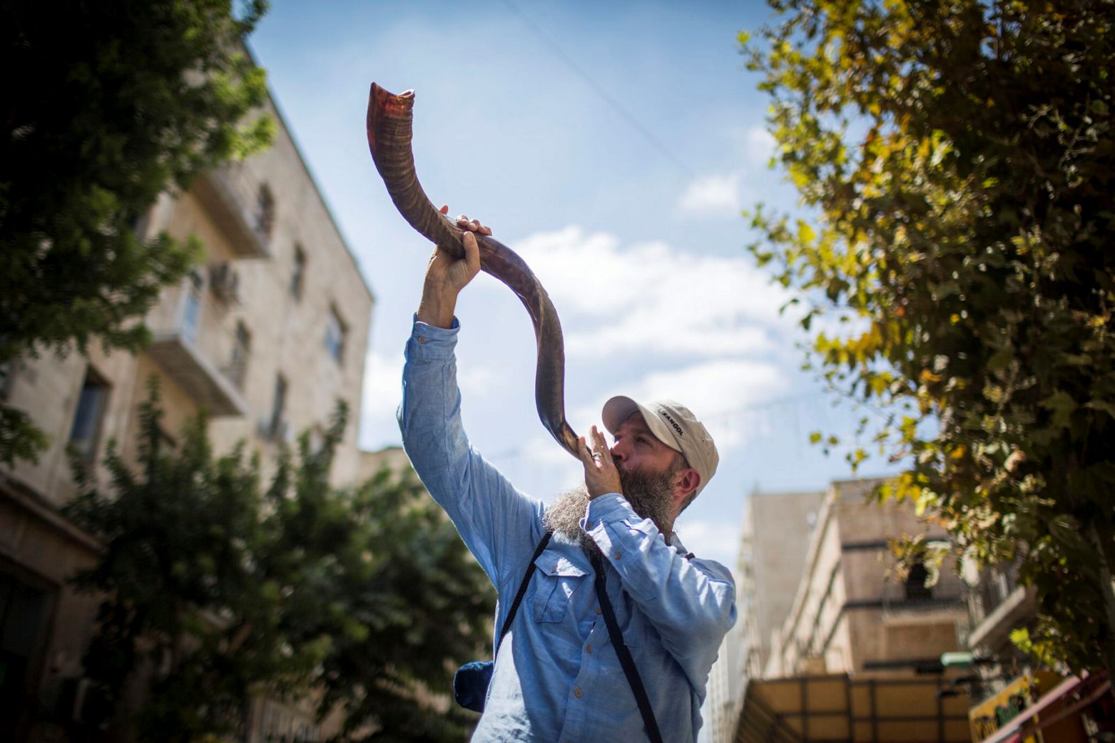 A tourist tries his hand at the shofar in Jerusalem. Photo by Hadas Parush/Flash90. 