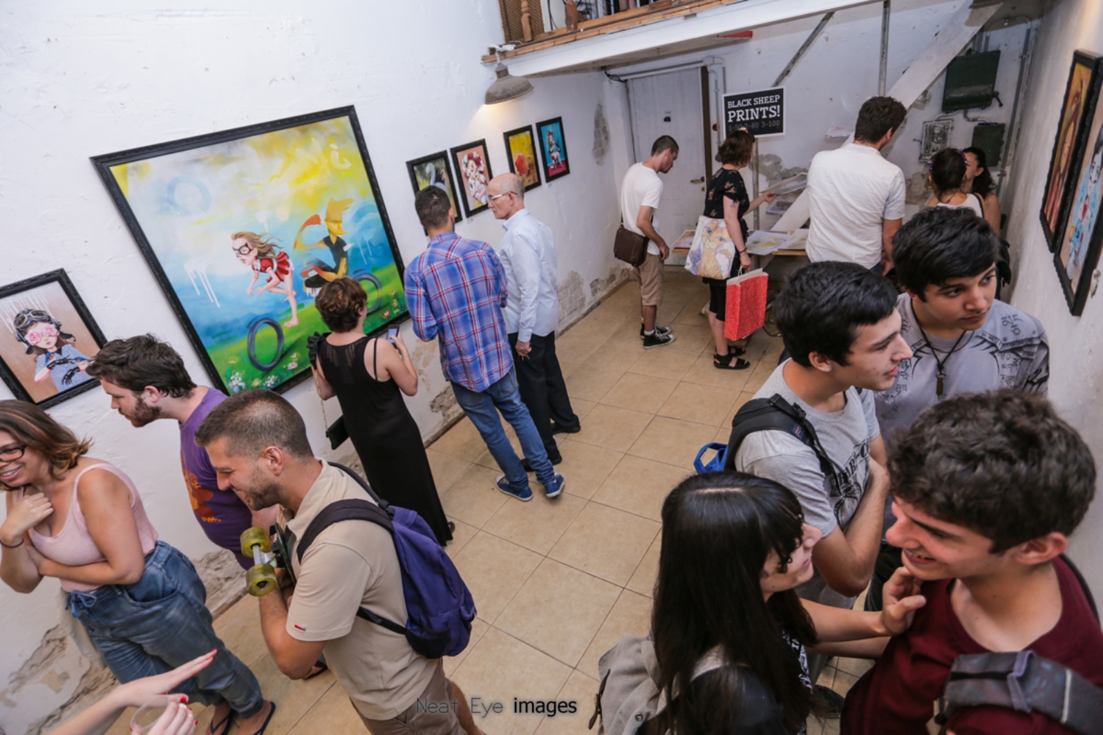Patrons enjoying street artist Untay’s show at Meshuna Gallery in Florentin. Photo by Neat Eye Images