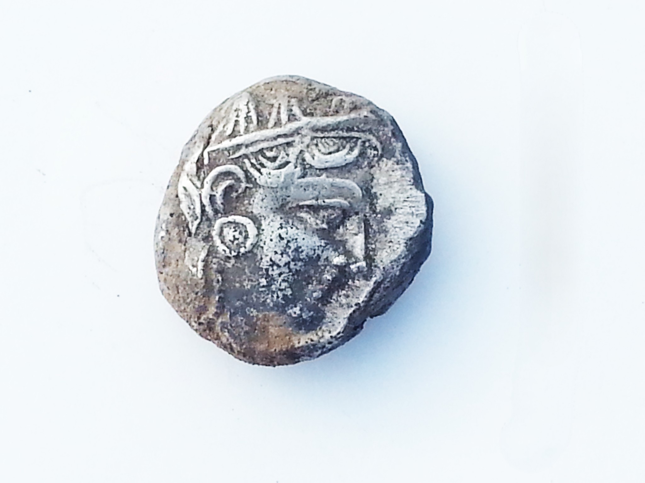 A silver coin that bears the likeness of the goddess Athena. Photo by Israel Antiquities Authority