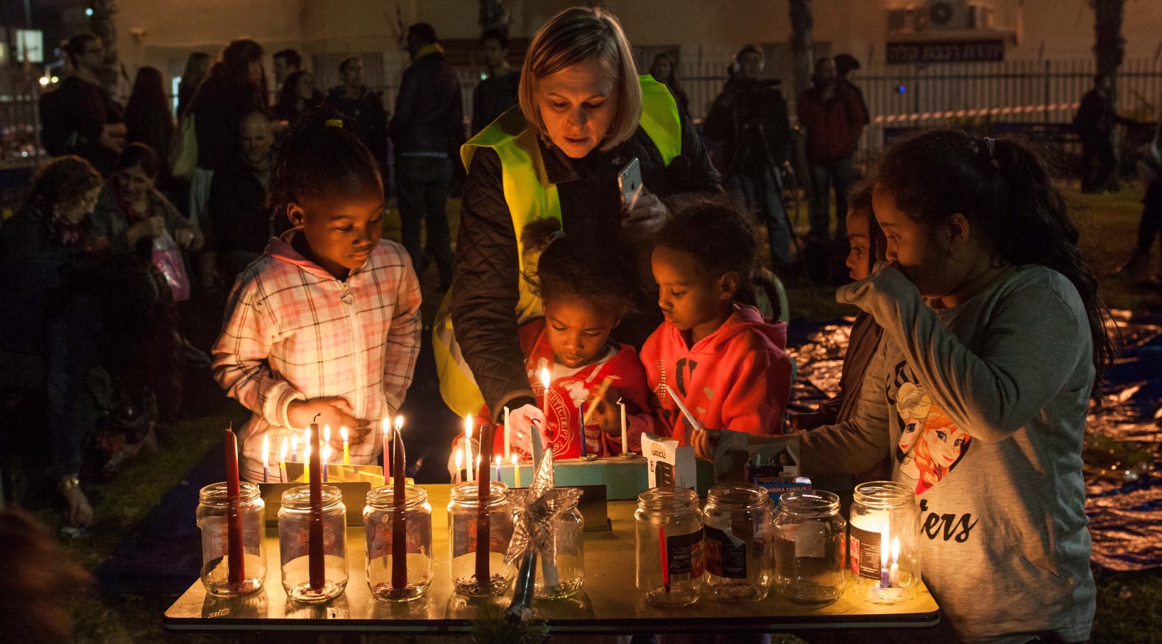 Children light candles for the fourth night of Hanukkah, December 9,2015. Photo by Esther Rubyan/FLASH90