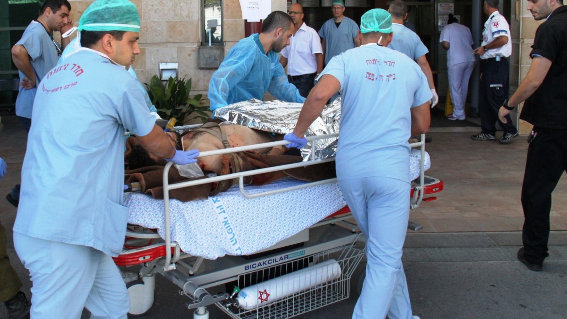 An injured civilian from the civil war in Syria being transferred to Ziv Medical Center in Israel. Photo by Simon Haddad 