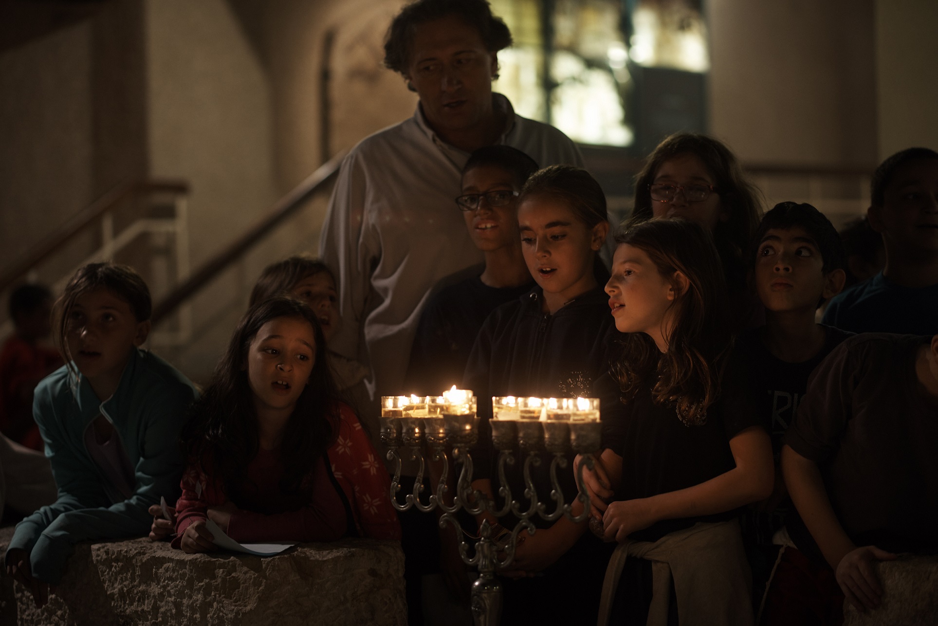 Children singing after lighting a hanukkiah in the Old City of Jerusalem. Photo by Yael Harman