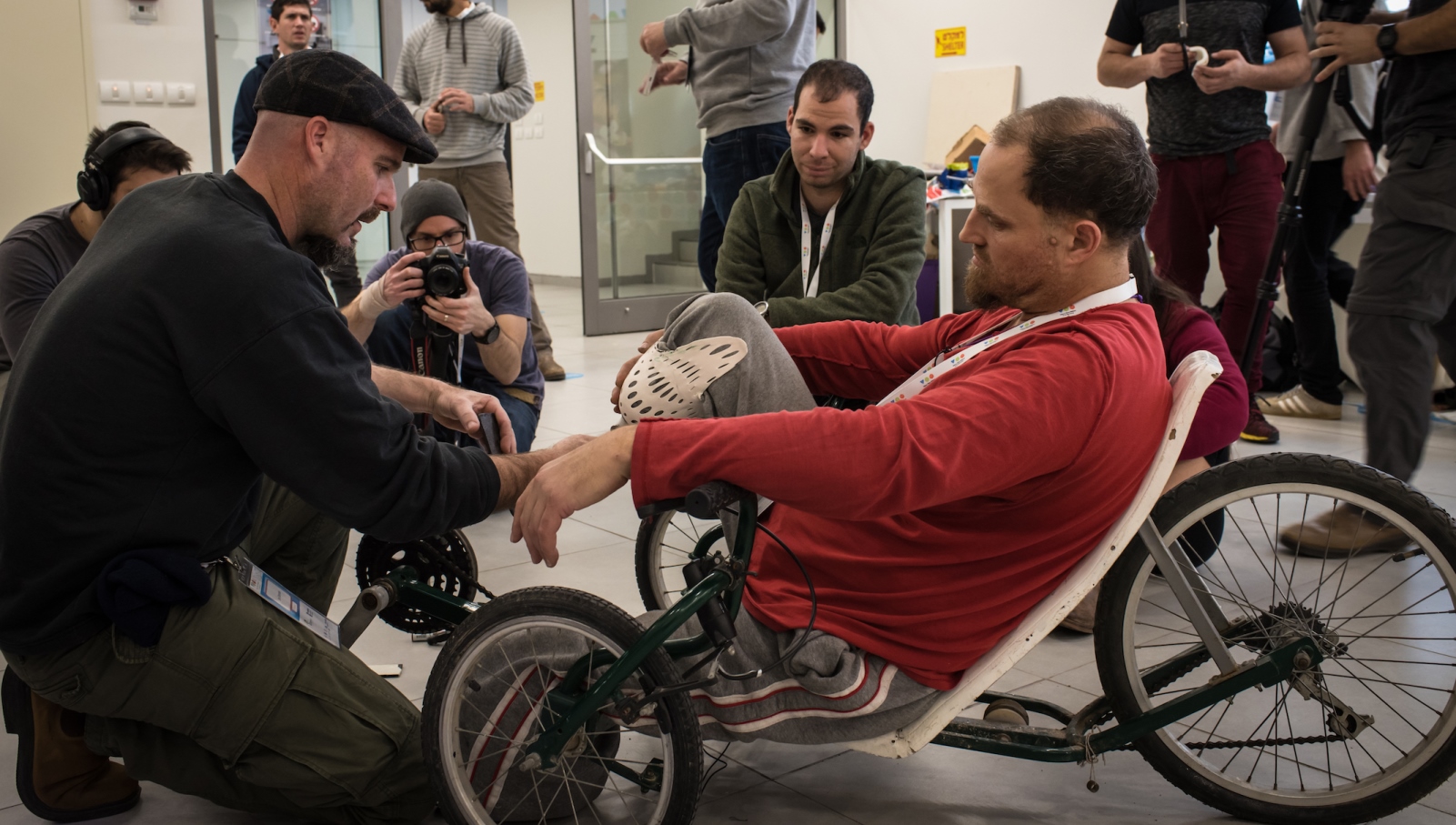 Amir Bartua and Ilan Sherman fitting a prosthetic leg in the Back to Biking project at TOM:Israel 2017. Photo courtesy of TOM:Tikkun Olam Makers 