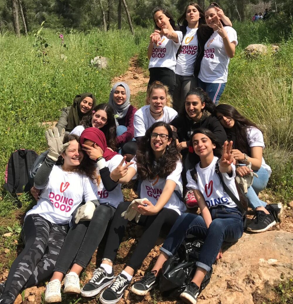 Arab and Jewish girls volunteered together to clear debris from a forest on Good Deeds Day in Israel. Photo courtesy of A New Way
